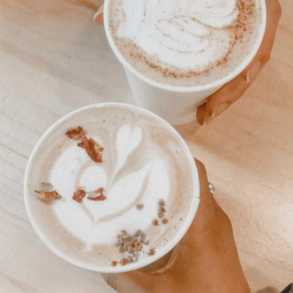 White poly cups filled with latte coffee
