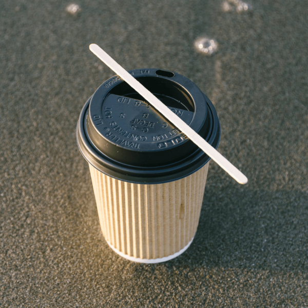 Wooden drinks stirrer on top of cup