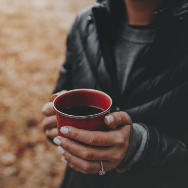 Close up of a woman holding a mug of cafe subito instant coffee