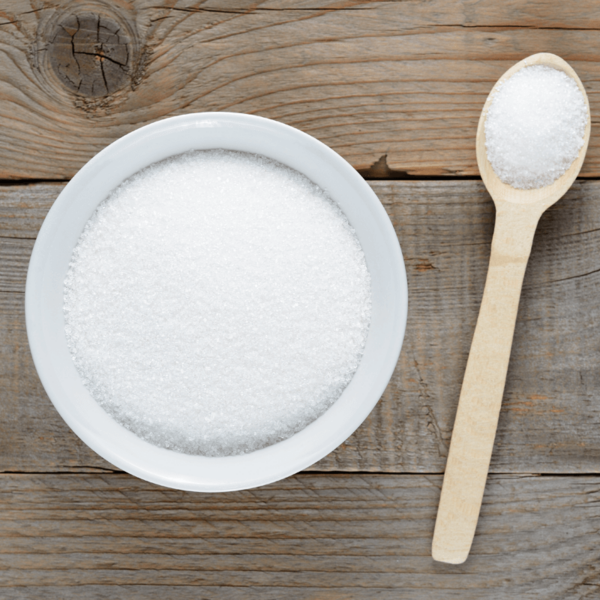 Bowl of sweetener with wooden spoon