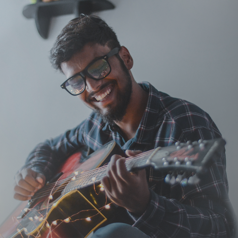 Happy man playing guitar