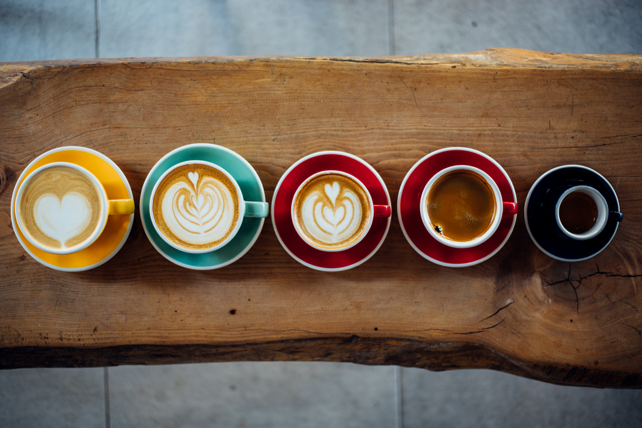 five different cups of coffee lined up in a row